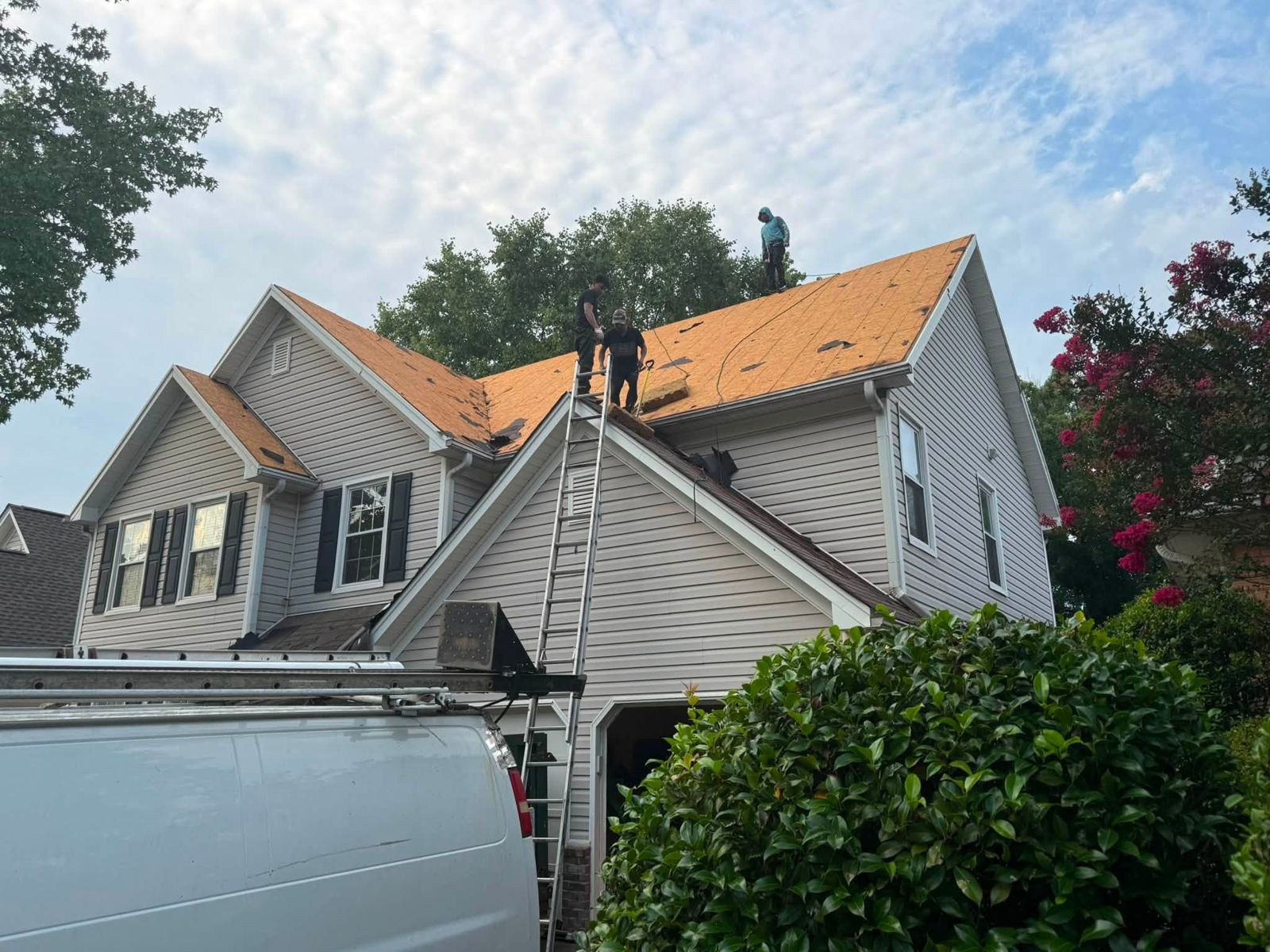 A Total Roofing crew on a roof during a tear-off